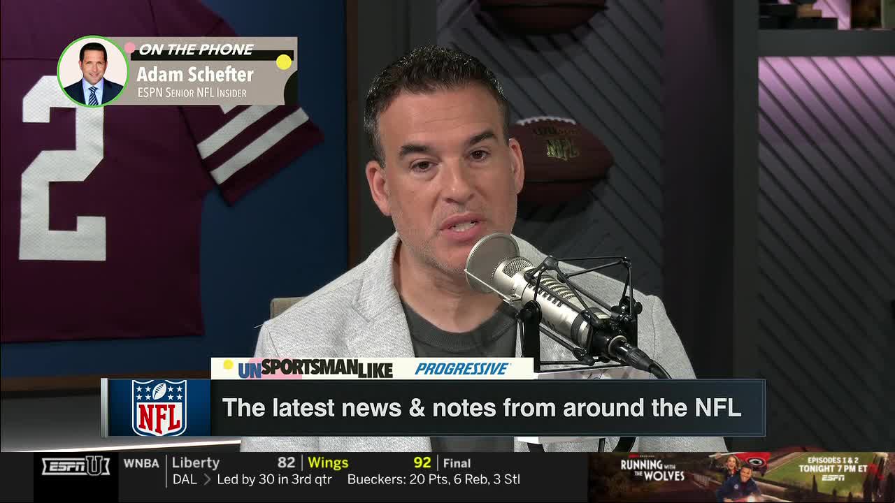 A man in a gray blazer speaks into a microphone, reporting on the latest NFL news. Above him, a graphic indicates Adam Schefter is on the phone, providing insight for ESPNU's coverage.
