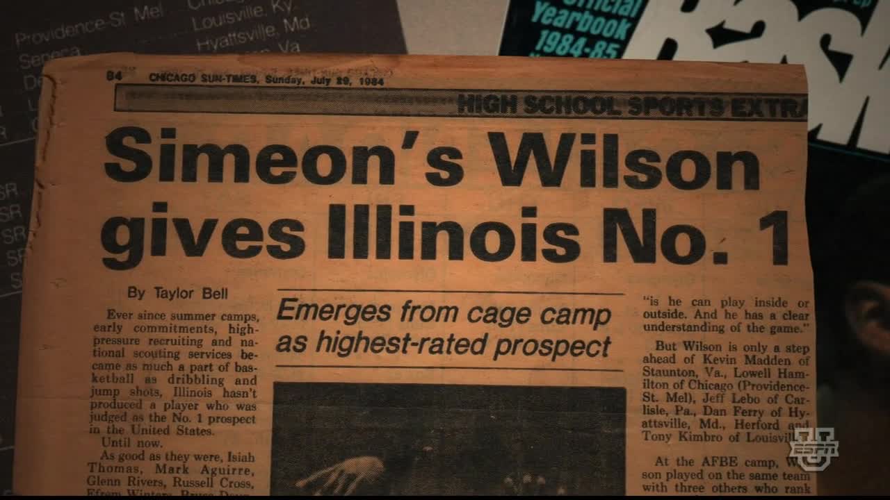 A yellowed newspaper headline announces Simeon's Wilson giving Illinois the number one spot. The article details the player's emergence as the highest-rated prospect in the United States.
