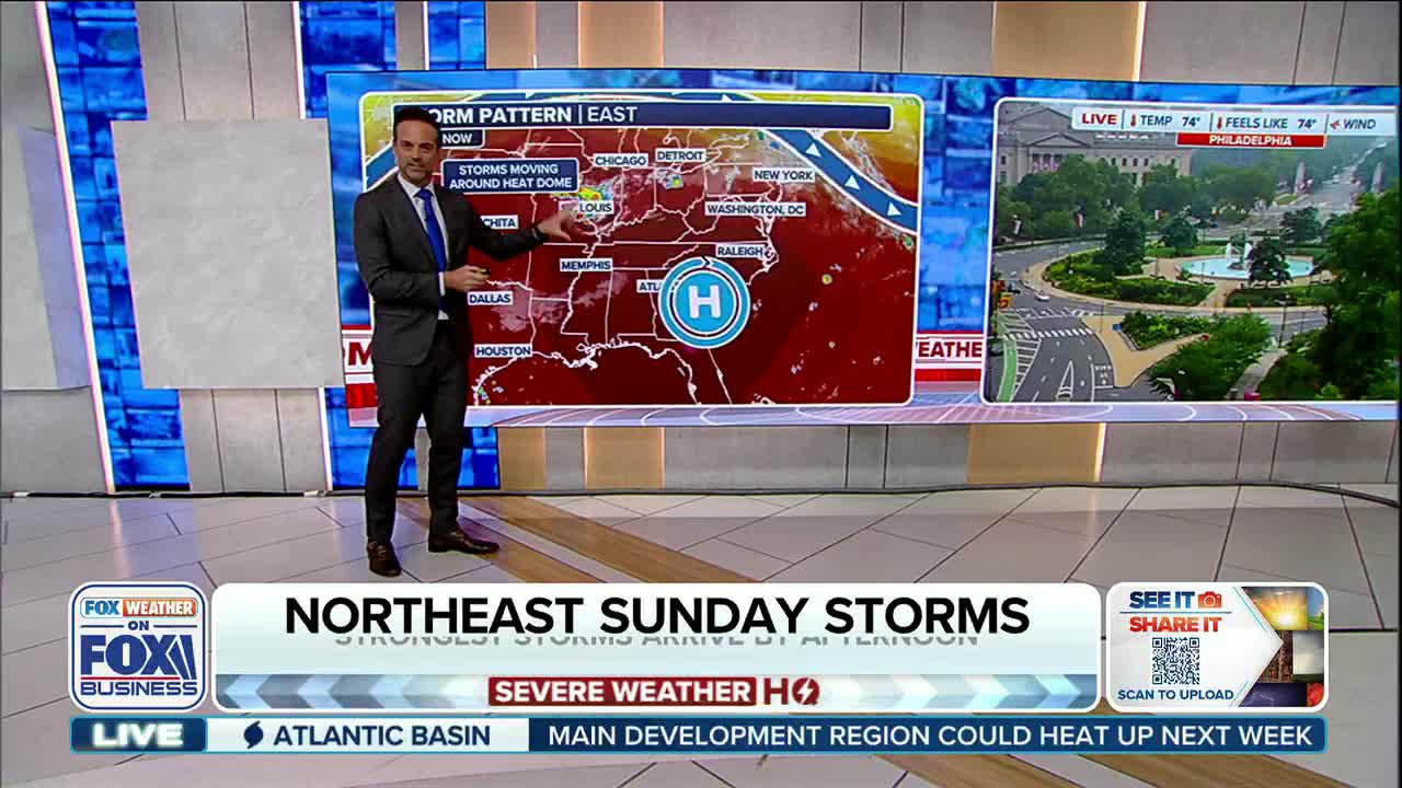 A man in a suit gestures toward a weather map of the United States on Fox Business Network. The map shows a heat dome and storm patterns over the eastern part of the country.
