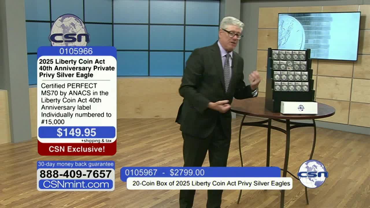 A man in a suit gestures toward a display of coins on a small table, likely on a Fox Business Network segment. Graphics on the screen advertise the sale of "2025 Liberty Coin Act" silver eagles.
