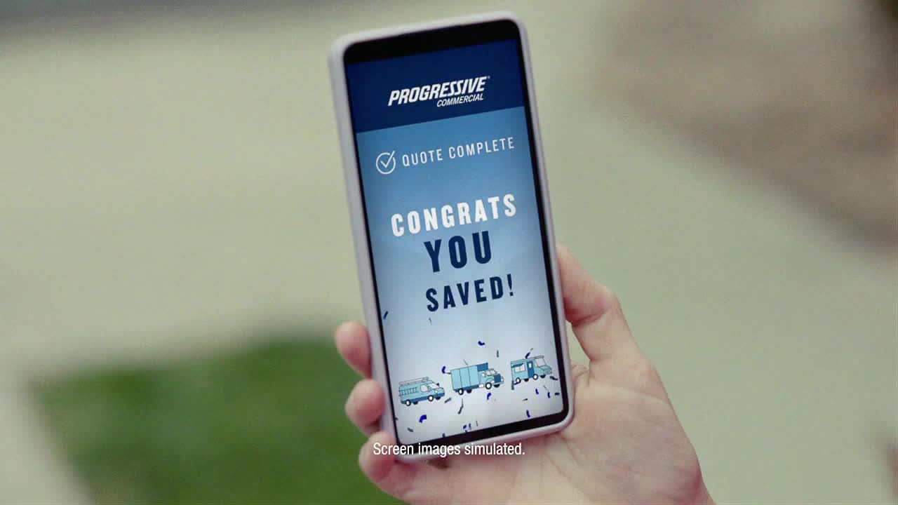 A hand holds a phone displaying a "Quote Complete" message from Progressive Commercial. The screen flashes "Congrats You Saved!" with confetti and cartoon trucks underneath, likely an ad on Fox Business Network in the United States.
