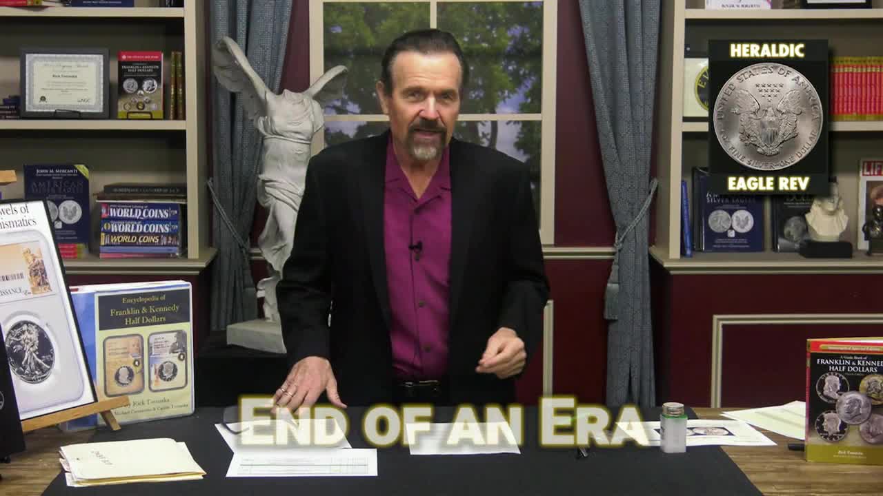 A man in a suit jacket, standing behind a desk, gestures with his hands while speaking. The words "END OF AN ERA" are displayed prominently at the bottom of the screen, and a coin is shown on the right side.
