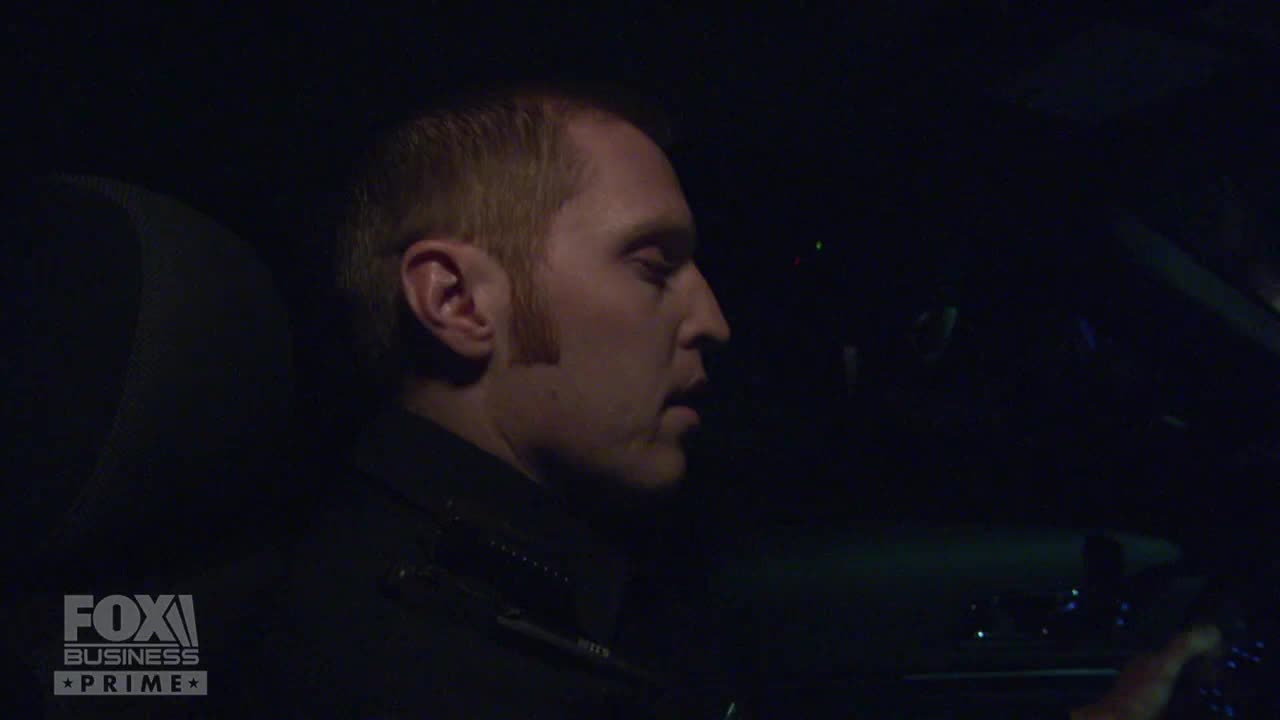 A man with fair hair is in the driver's seat, speaking. The Fox Business Network logo is visible in the corner.
