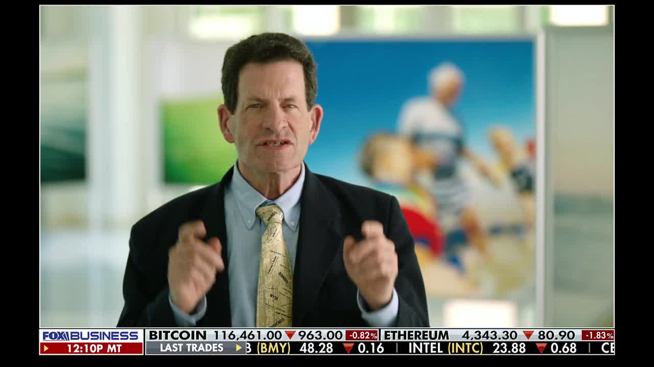 A man in a suit gestures with his hands on a Fox Business Network broadcast. Below, stock market data scrolls across the bottom of the screen.
