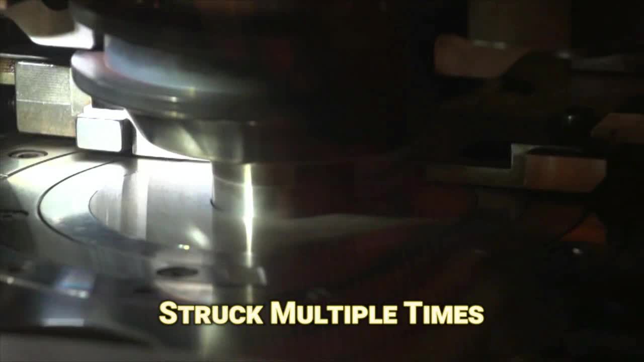 A shiny metal disc spins as a mechanical arm repeatedly strikes it. The Fox Business Network graphic reads "Struck Multiple Times" across the bottom.
