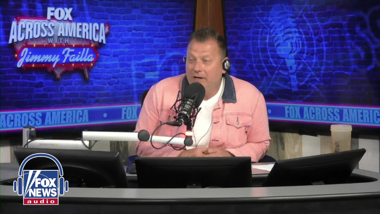 The host of "Fox Across America with Jimmy Failla" is speaking into a microphone, his face lit by the studio lights. Behind him, a blue backdrop displays the show's logo and the Fox News Radio branding.
