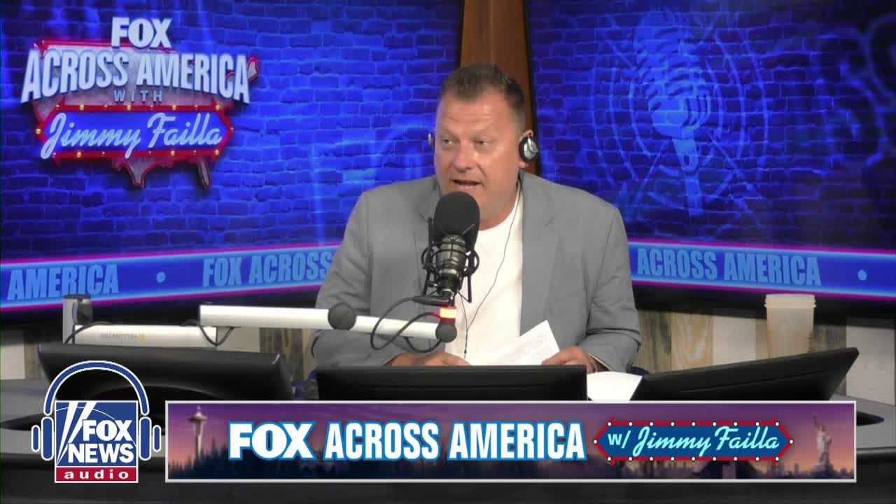 Jimmy Failla, on Fox News Radio, is speaking into a microphone, a script in his hand. The "Fox Across America" backdrop and logo are visible behind him.
