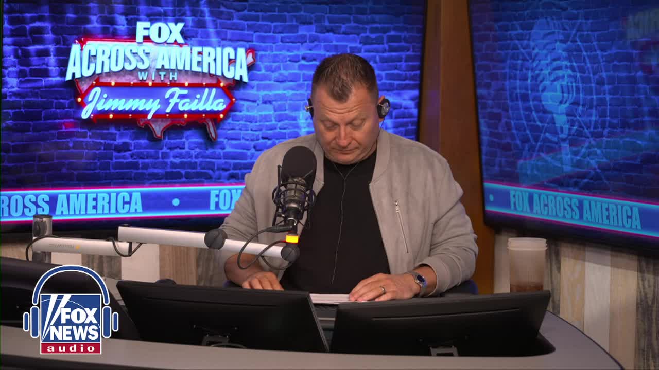 Jimmy Failla, on Fox News Radio, is seated at a desk, looking down at some papers. He's wearing a headset and a light jacket, with the "Fox Across America" logo prominently displayed behind him.
