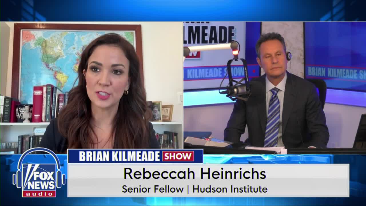 A woman speaks animatedly from a bookshelf-lined room, while a man in a suit and tie listens intently in a studio. The Fox News Audio logo and "Brian Kilmeade Show" graphic are visible.