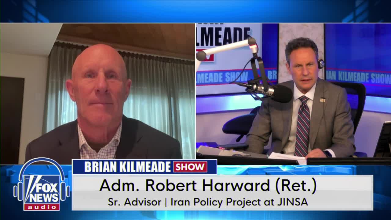 Brian Kilmeade sits at his desk, speaking into a microphone for the Fox News Radio show. On the screen, Admiral Robert Harward (Ret.) appears in a split-screen, offering his perspective.