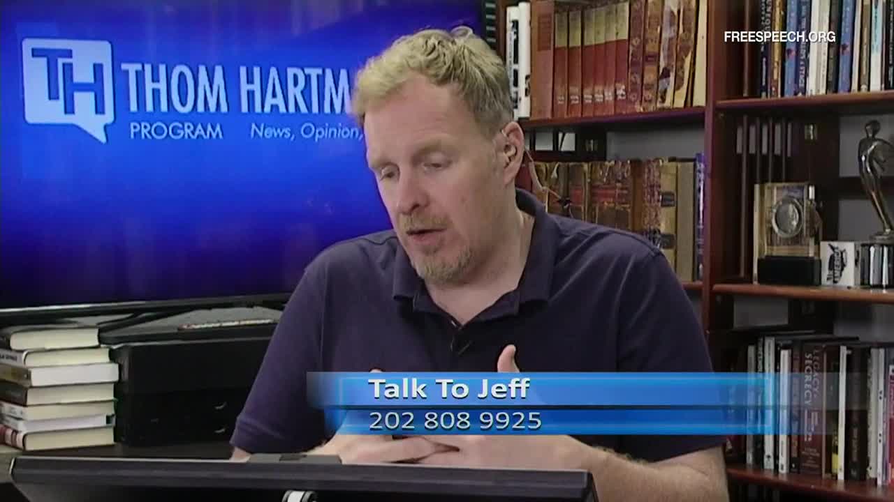 A man with reddish-blond hair is speaking on Free Speech TV's "Thom Hartmann Program." Below him, a graphic encourages viewers to "Talk to Jeff" and provides a phone number.
