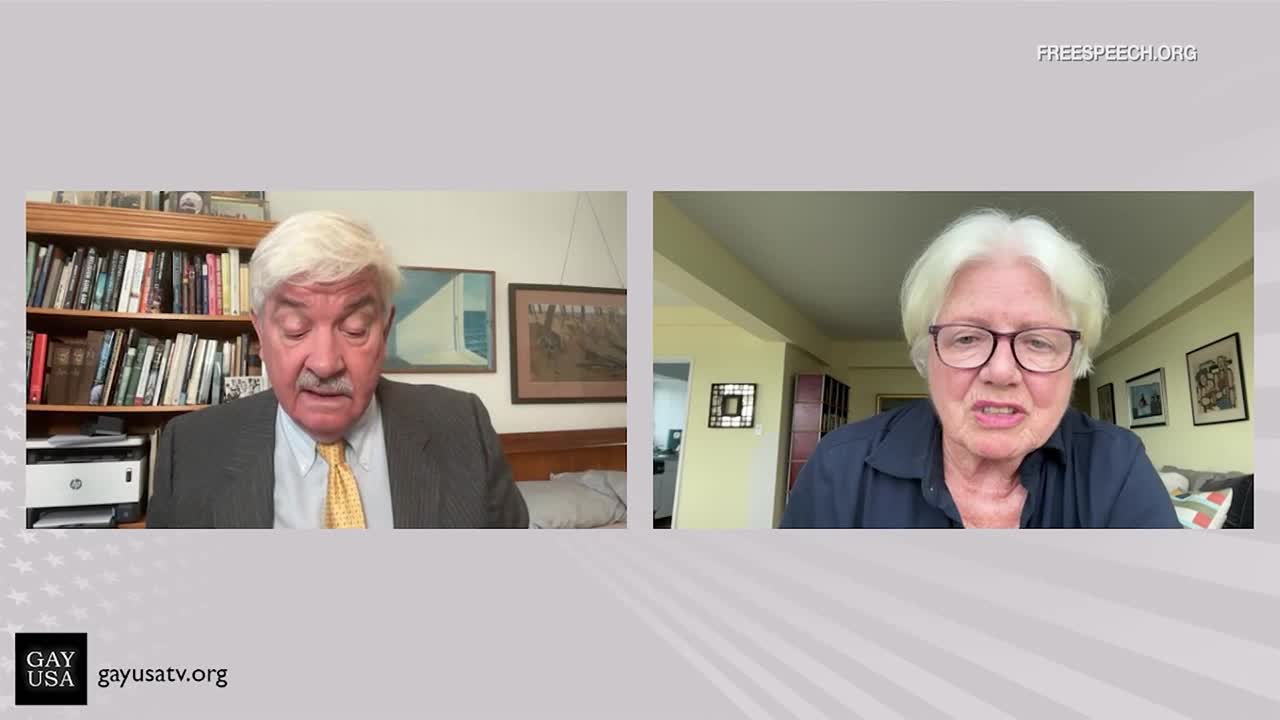 Two people are on a split screen, likely for a Free Speech TV interview. The man on the left, in a suit and tie, is speaking while the woman on the right, wearing glasses, appears to be responding.
