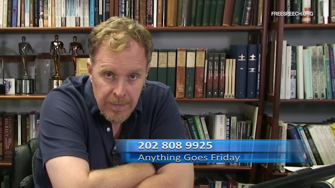 A man with reddish-blond hair sits in front of a bookshelf, looking directly at the camera. The phone number and show title "Anything Goes Friday" are displayed on a blue banner at the bottom of the screen.
