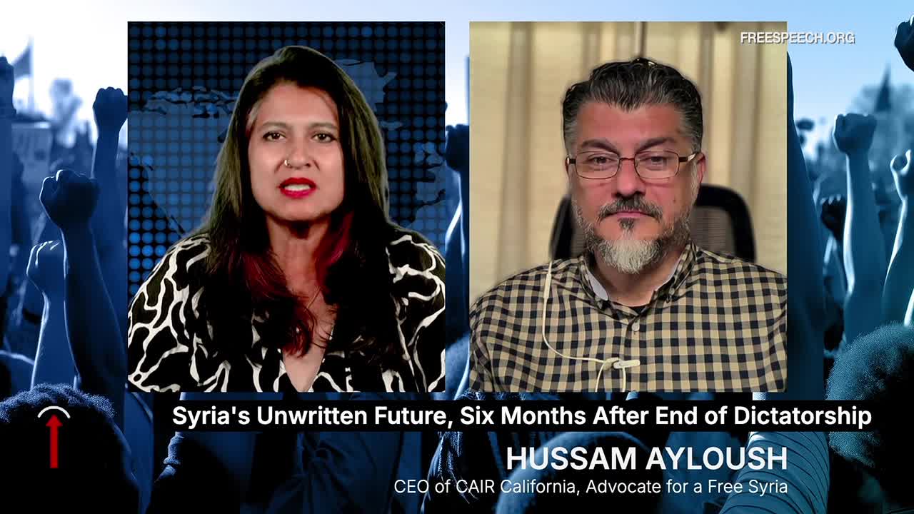 On Free Speech TV, two people are in separate video frames, discussing Syria. The woman on the left is speaking, while the man on the right listens, his face framed by a beard and glasses.
