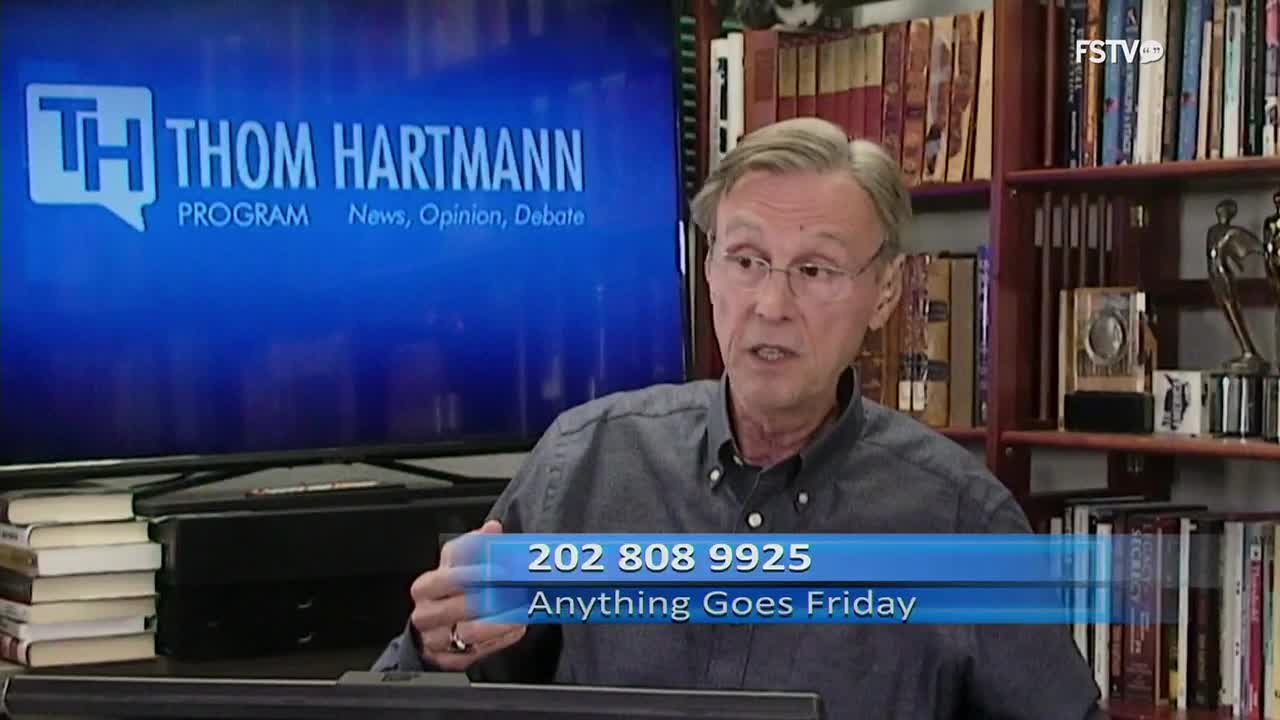 Thom Hartmann, on the set of his show, is speaking directly to the camera. A phone number and the words "Anything Goes Friday" are displayed across the bottom of the screen.
