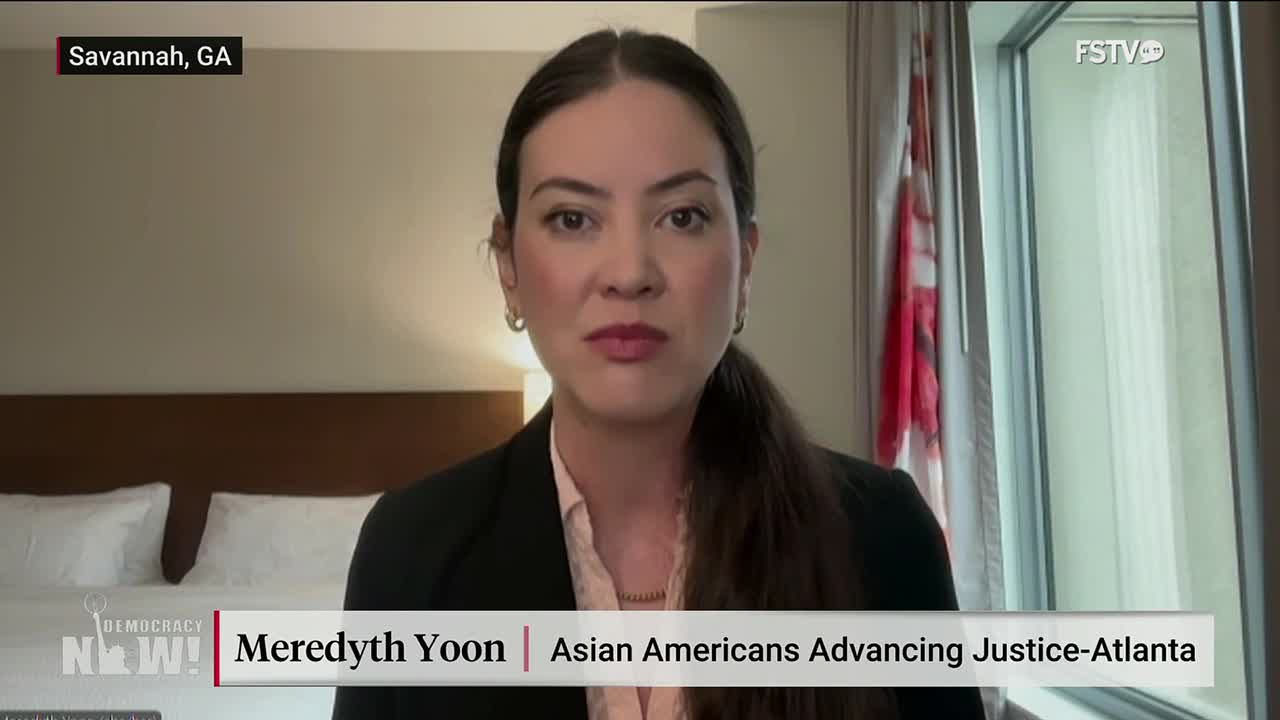 Meredyth Yoon, from Asian Americans Advancing Justice-Atlanta, is speaking on Free Speech TV. She's framed against a window with a red and white flag visible.
