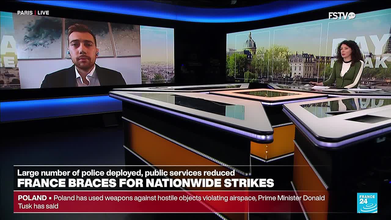 A news anchor sits at a desk, while a man in a suit appears on a screen behind her. The lower third of the screen displays a headline about France and strikes.
