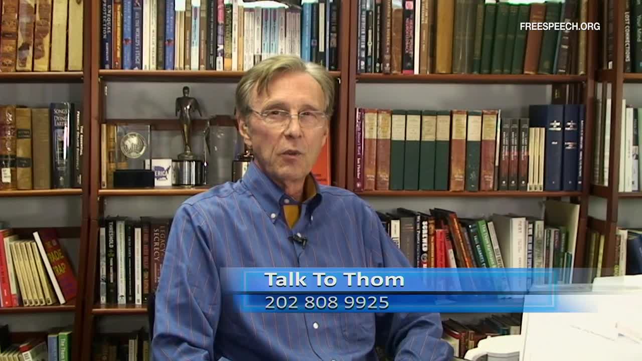 The man in the blue shirt is speaking, framed by bookshelves and a "Talk To Thom" graphic. Free Speech TV's logo is visible in the corner.
