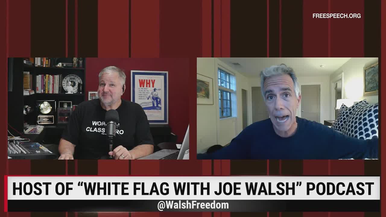 Joe Walsh, host of the "White Flag" podcast, gestures animatedly from a home setting, while another man in a "World Class Hero" t-shirt smiles into a microphone. The Free Speech TV graphic identifies the show.
