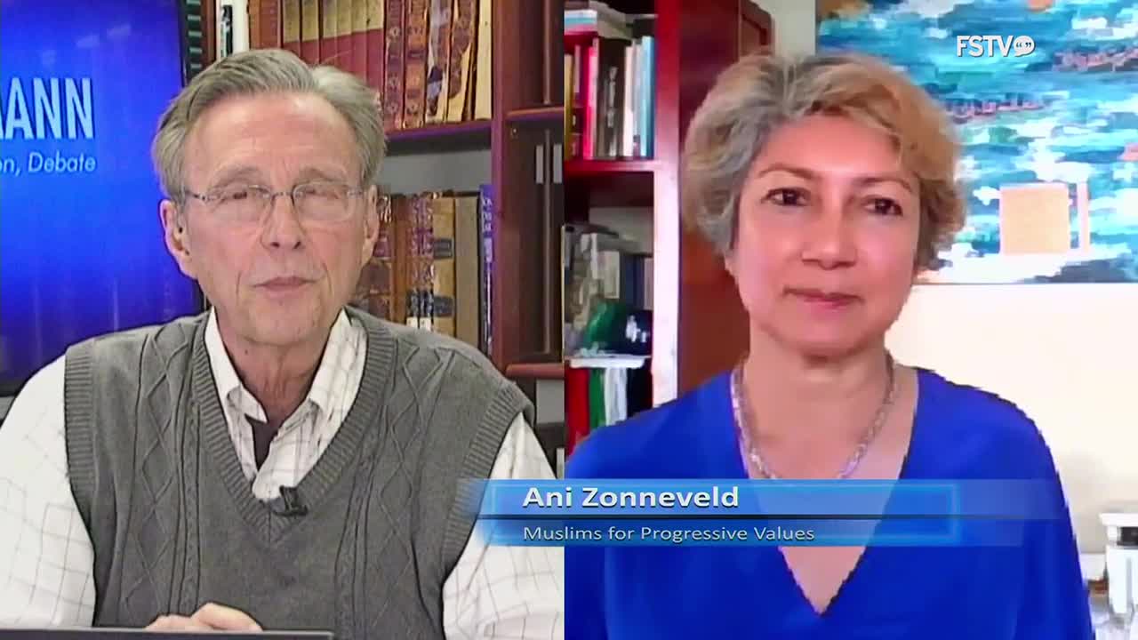 On Free Speech TV, two people are in a split-screen interview. Ani Zonneveld, identified as being from "Muslims for Progressive Values," is smiling, while the other man looks directly at the camera.
