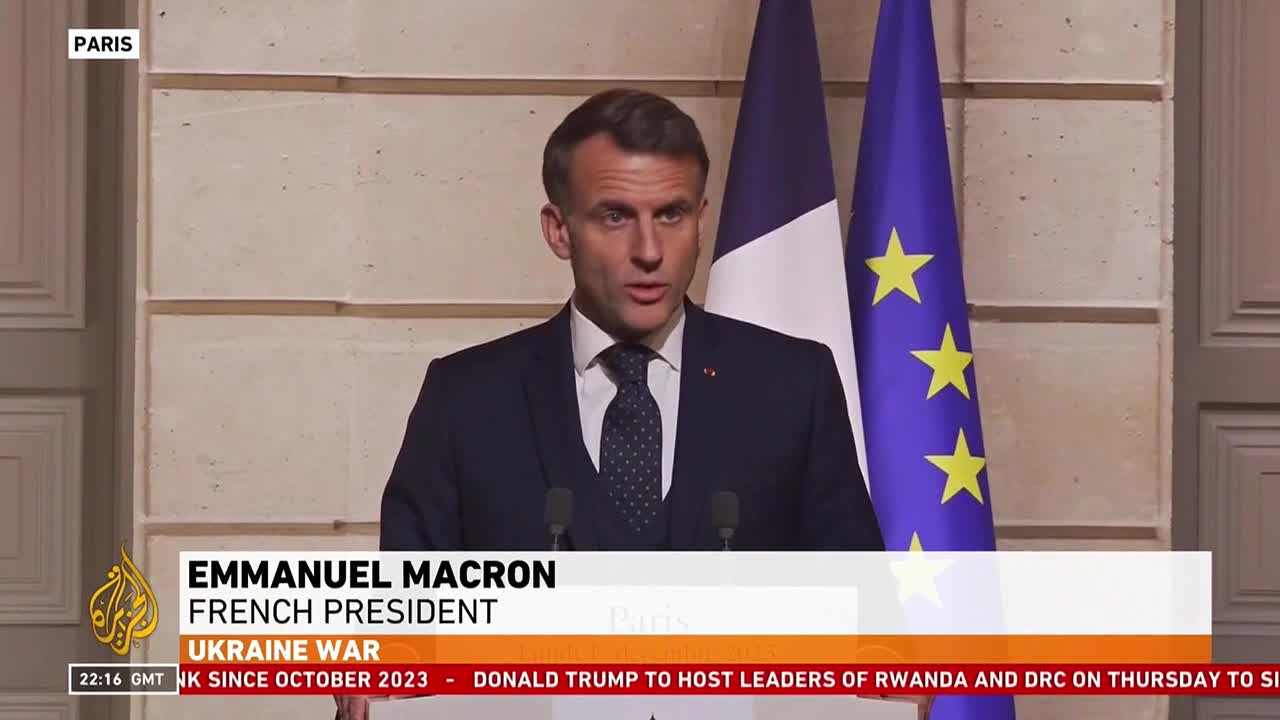 Emmanuel Macron, the French President, is speaking at a podium, his face animated. Behind him, the flags of France and the European Union stand tall.
