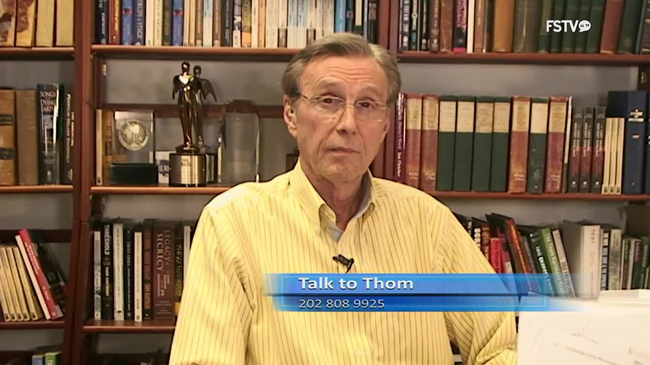 A man in a yellow striped shirt speaks directly to the camera, framed by bookshelves. A blue graphic overlay reads "Talk to Thom" with a phone number below it.