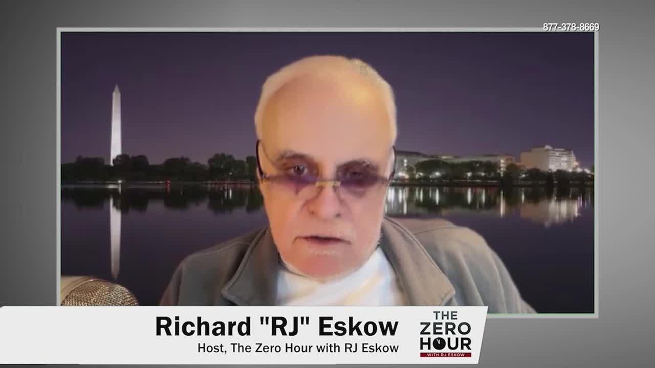 Richard "RJ" Eskow speaks directly to the camera, his face illuminated by studio lights. Behind him, the Washington Monument stands tall against a twilight sky reflected in calm water.