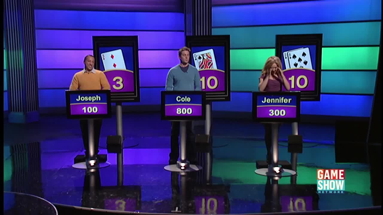 Three contestants stand at podiums, each with a card displayed above their heads on a Game Show Network set. Jennifer covers her face, while Cole and Joseph look on, seemingly awaiting the next round.
