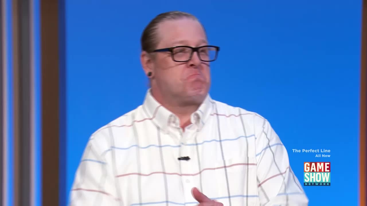 A man in a checkered shirt squints, his mouth pursed. He's on the Game Show Network set for "The Perfect Line."
