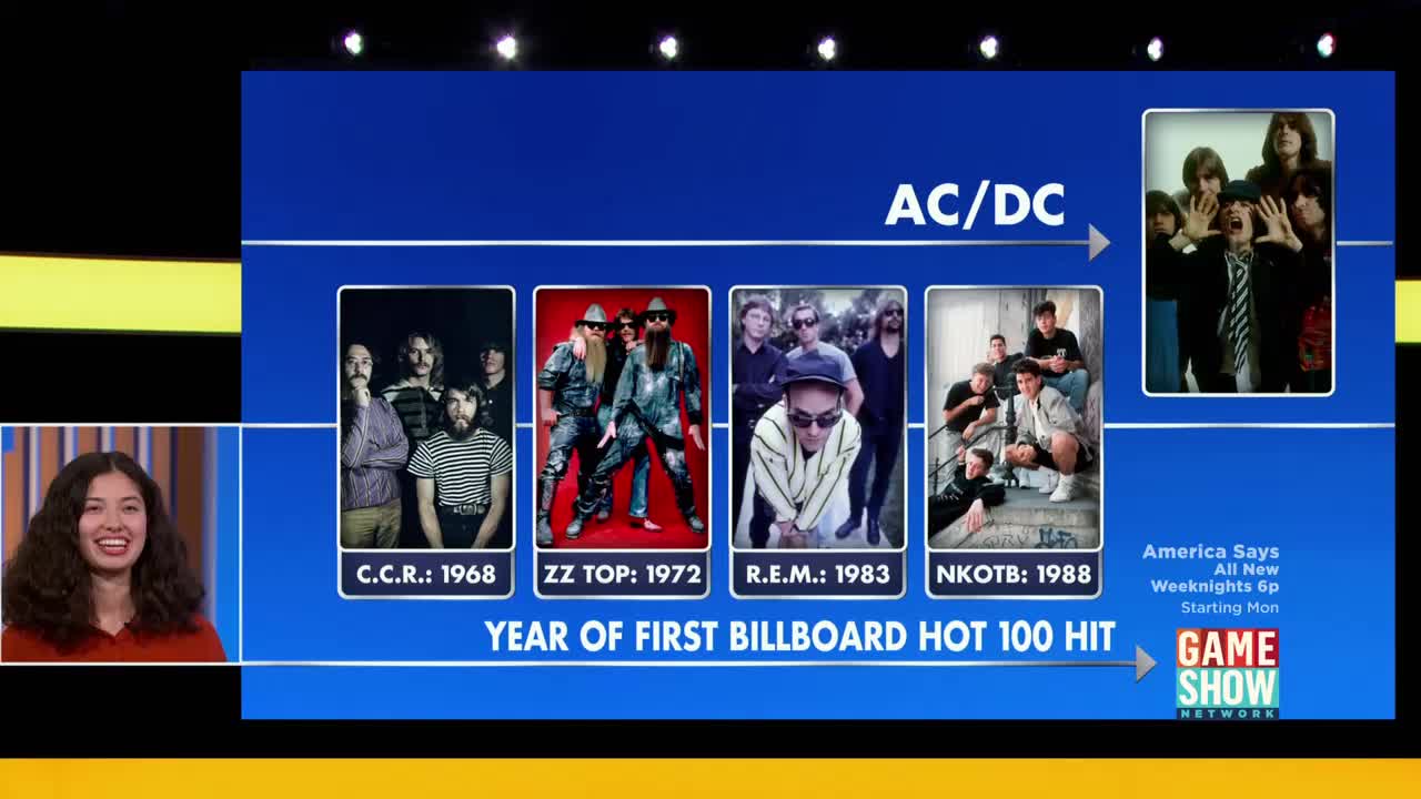 The screen displays a timeline of bands and their first Billboard Hot 100 hit years. A woman on the left smiles as the Game Show Network logo appears.