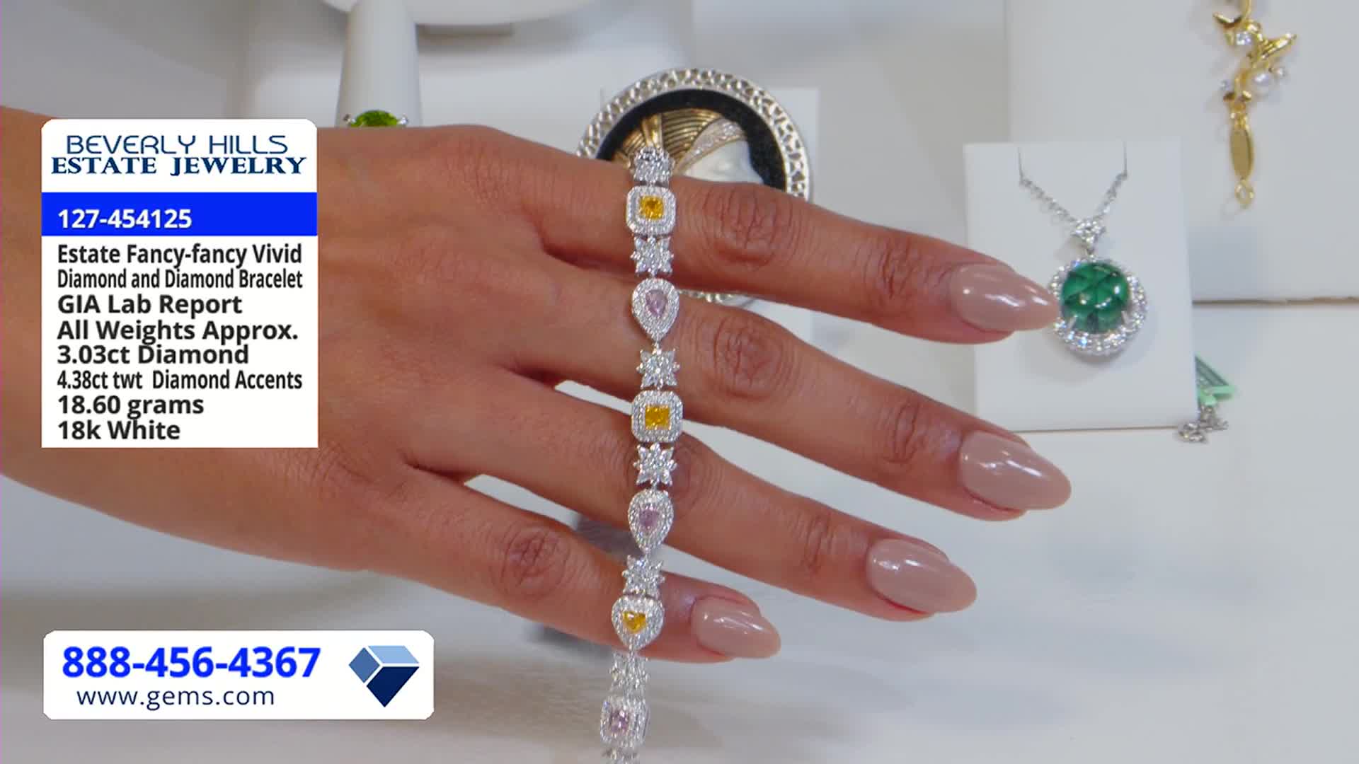 A wrist displays a bracelet with alternating yellow and pink diamond shapes. The Gem Shopping Network logo and details about the jewelry are displayed on the screen.
