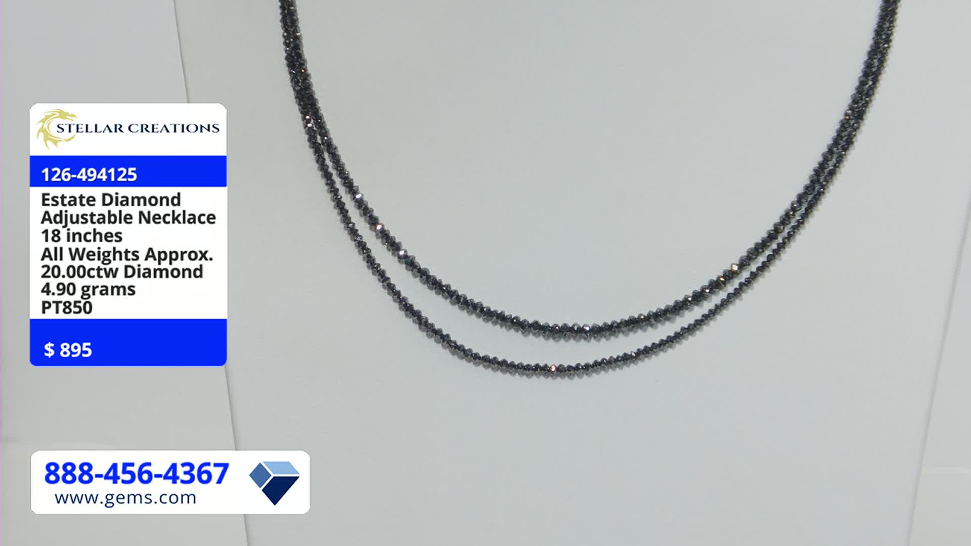 A double strand necklace, strung with tiny, dark beads, hangs against a white backdrop. The Gem Shopping Network display shows the price of the estate diamond necklace as $895.
