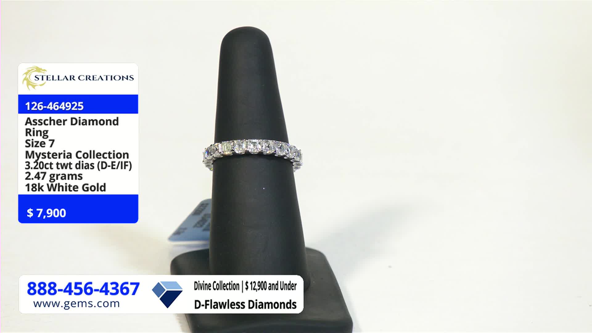 A diamond ring, set with multiple square-cut stones, sits on a black display stand. The Gem Shopping Network's price tag shows the ring is selling for $7,900.
