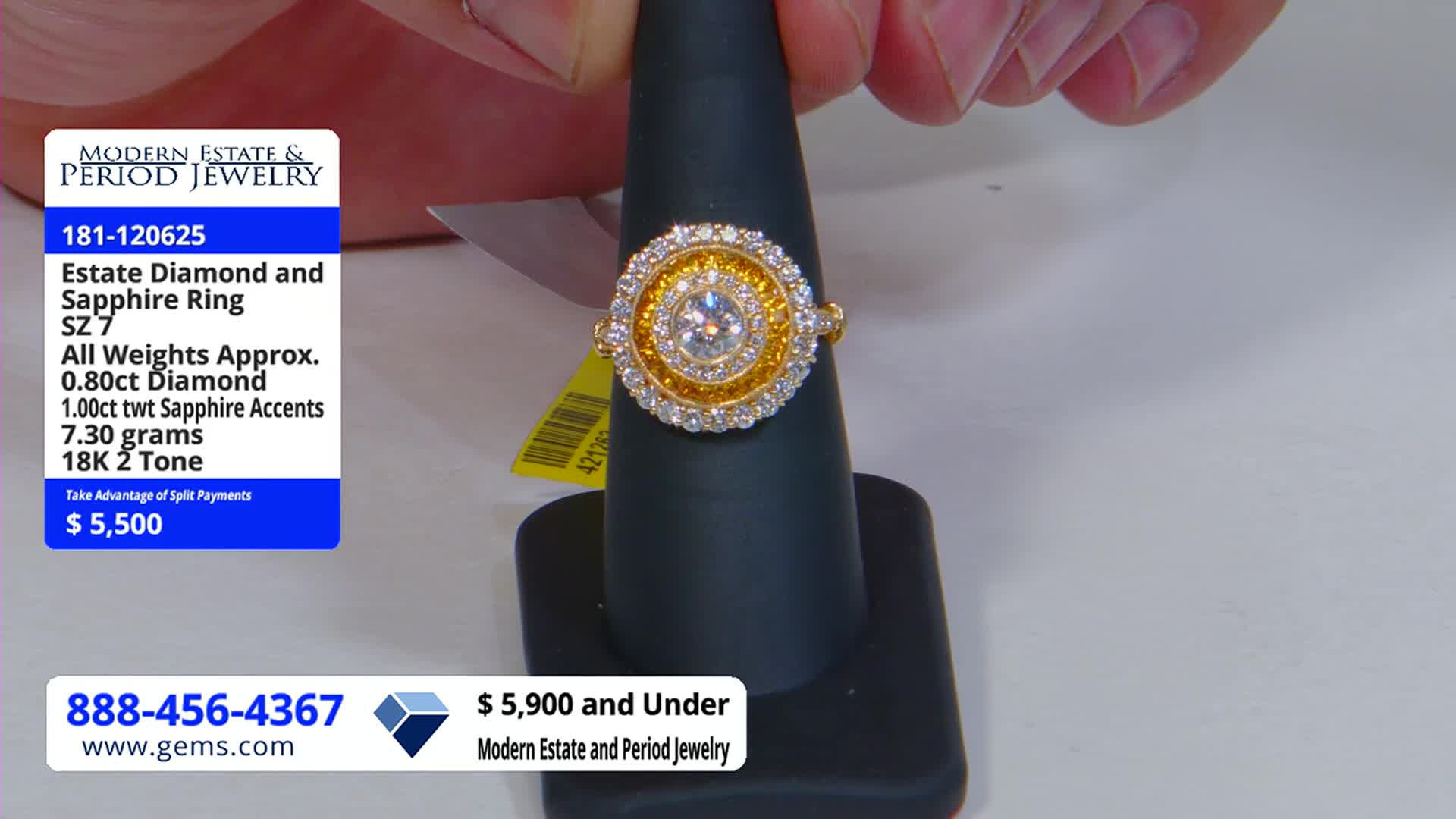 A gold and diamond ring, set with a large central stone, is displayed on a black stand. The ring's price, $5,500, is listed on a graphic from the Gem Shopping Network.
