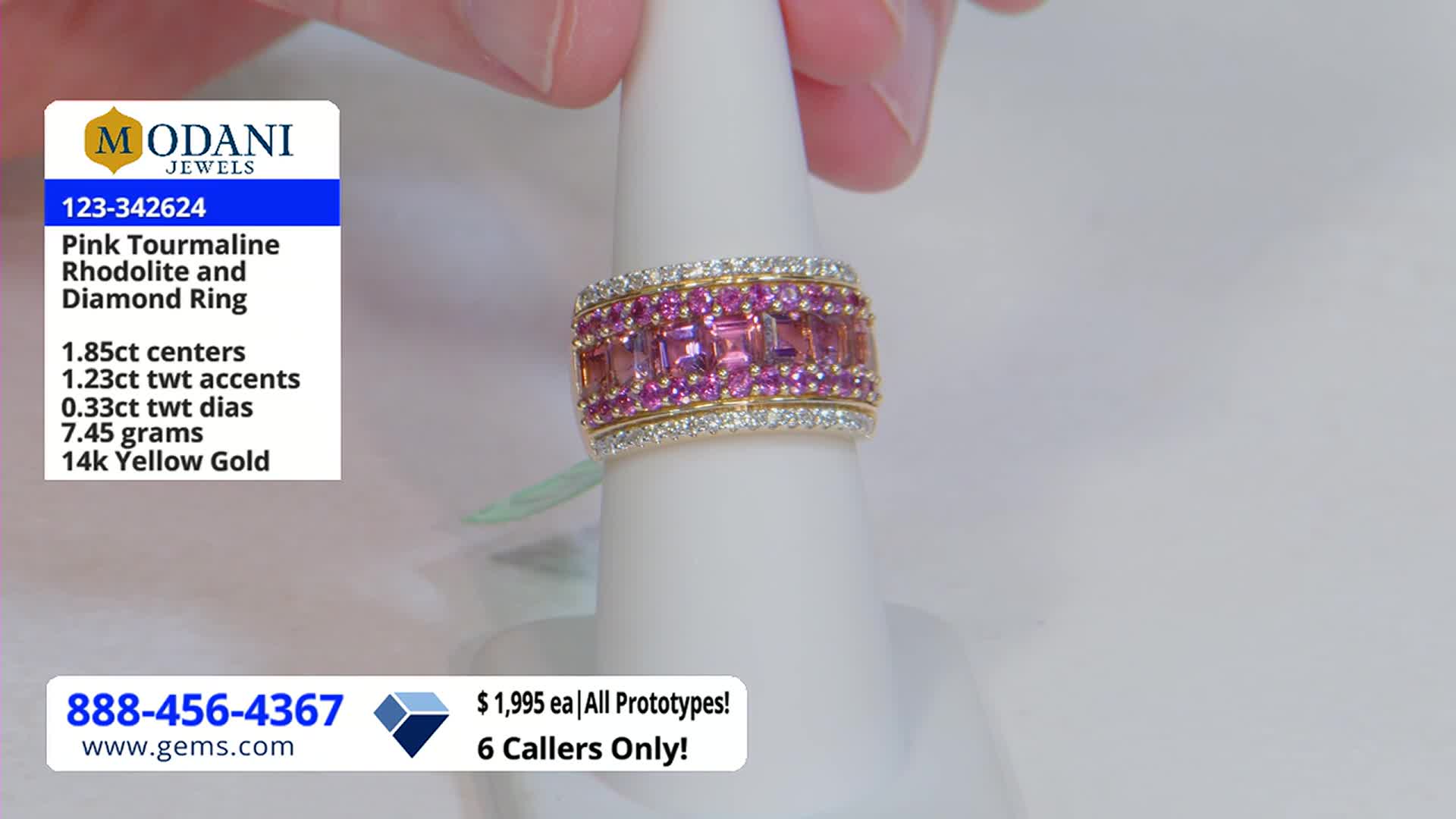 A hand holds a ring, showcasing its pink and diamond accents on a white stand. The Gem Shopping Network logo and price information are visible in the corner.
