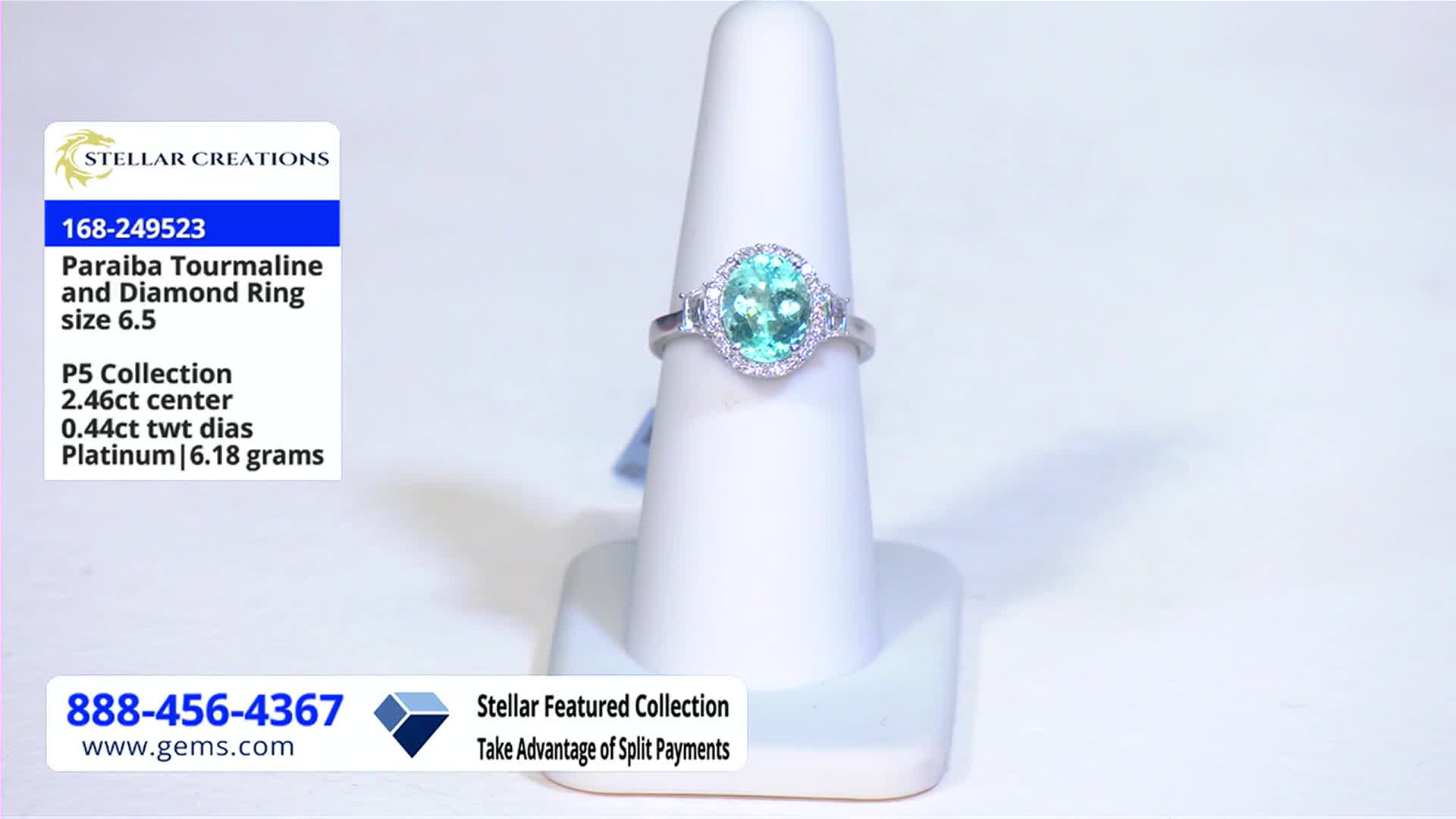 A ring with a bright teal stone sits on a white display stand. The Gem Shopping Network logo and product details are visible in the corner.
