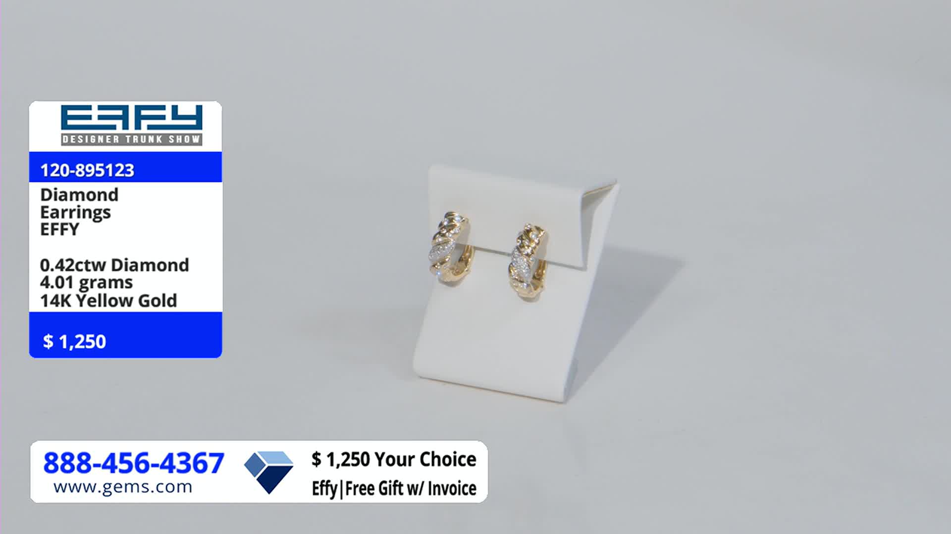 On a white pedestal, a pair of gold hoop earrings with diamond accents are displayed. The Gem Shopping Network's price tag shows they're selling for $1,250.
