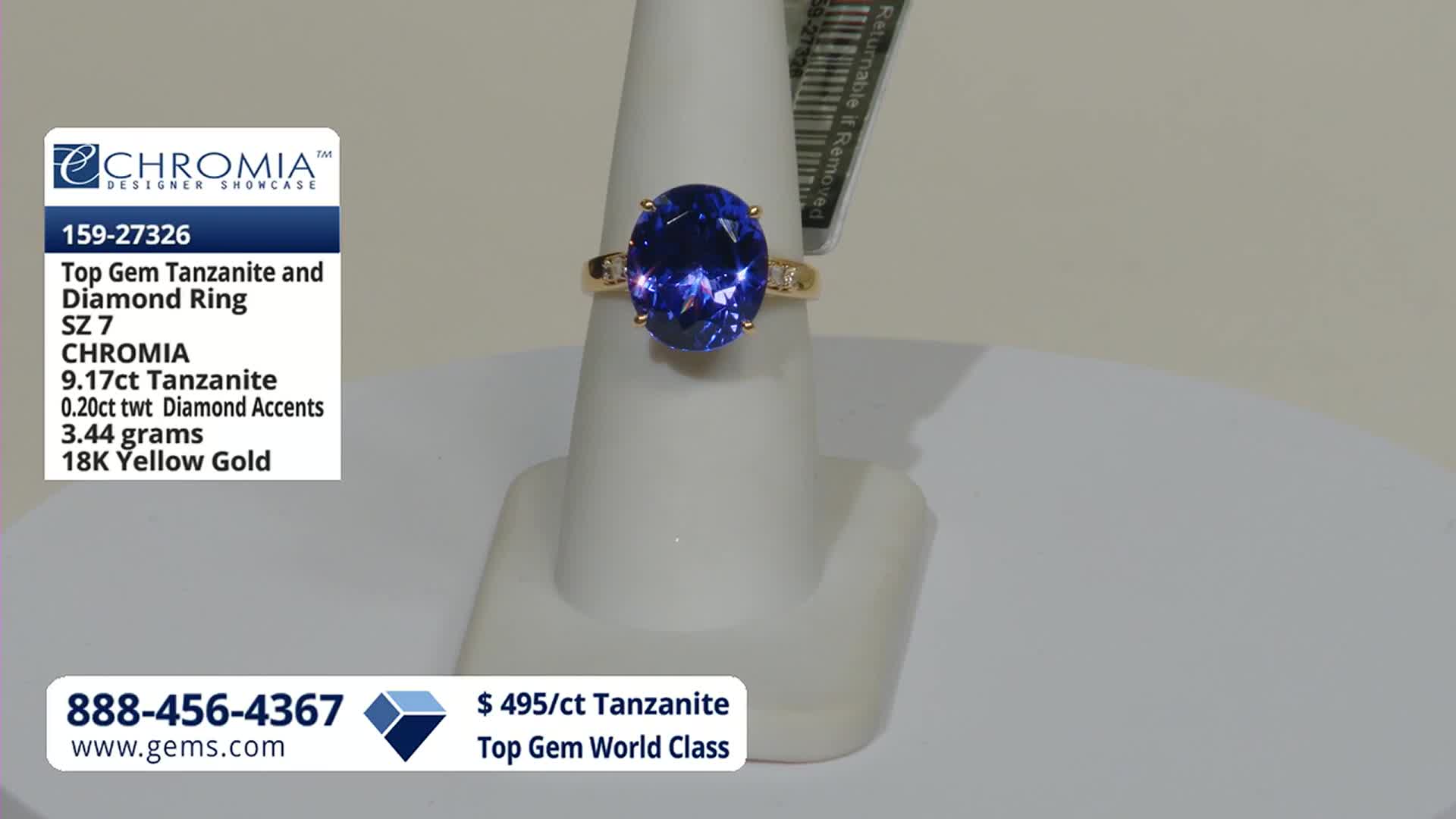 A large oval tanzanite ring sits on a display stand. The Gem Shopping Network logo and details about the ring are visible on the left.