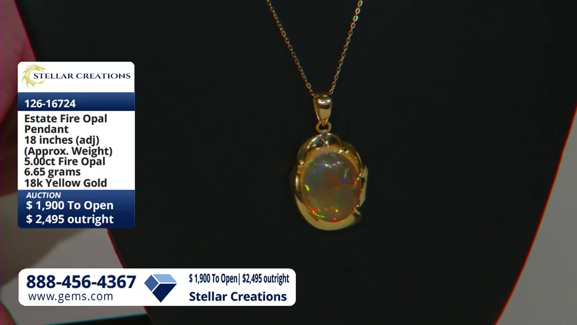 A gold pendant with a fire opal hangs from a delicate chain. The gem flashes with internal colors as it's displayed on the Gem Shopping Network.
