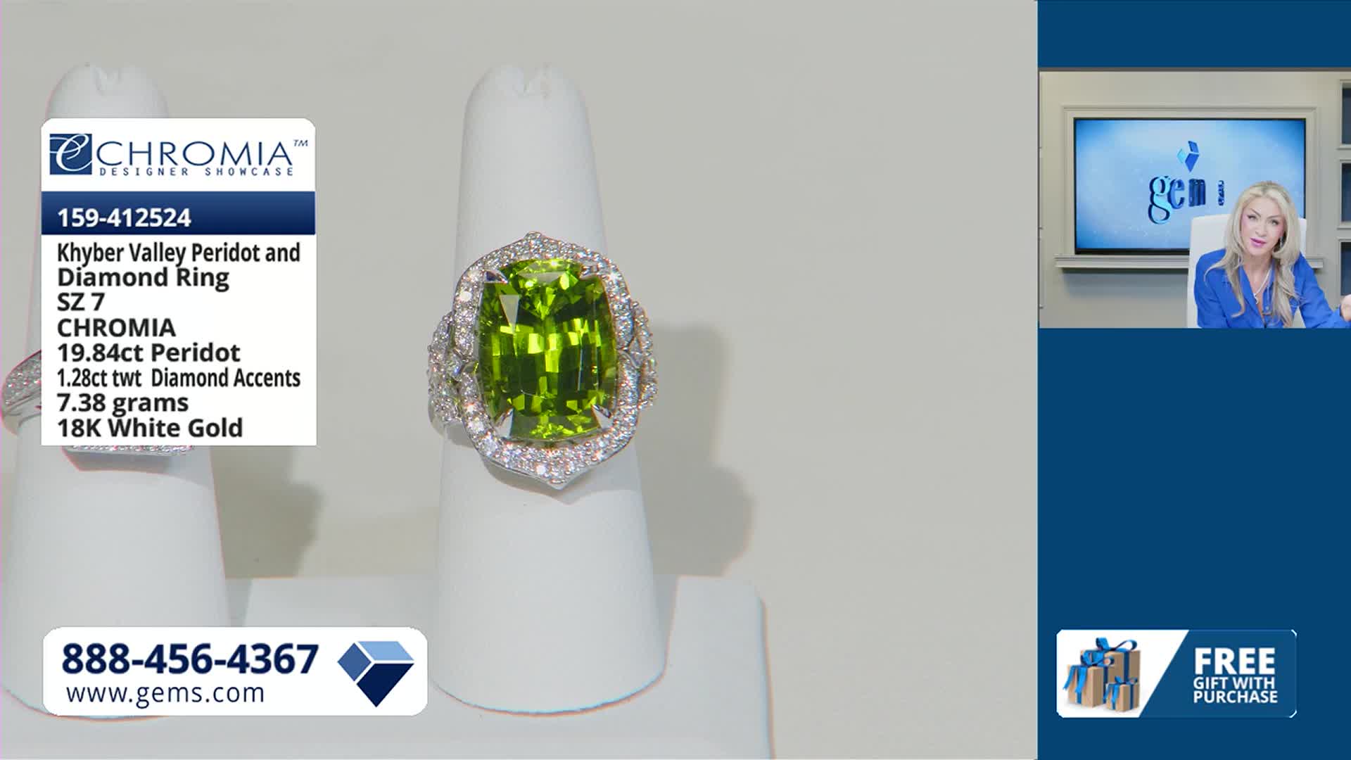 A large, cushion-cut peridot ring, surrounded by diamonds, sits on a white display. A woman in a blue blouse speaks from a screen in the background.