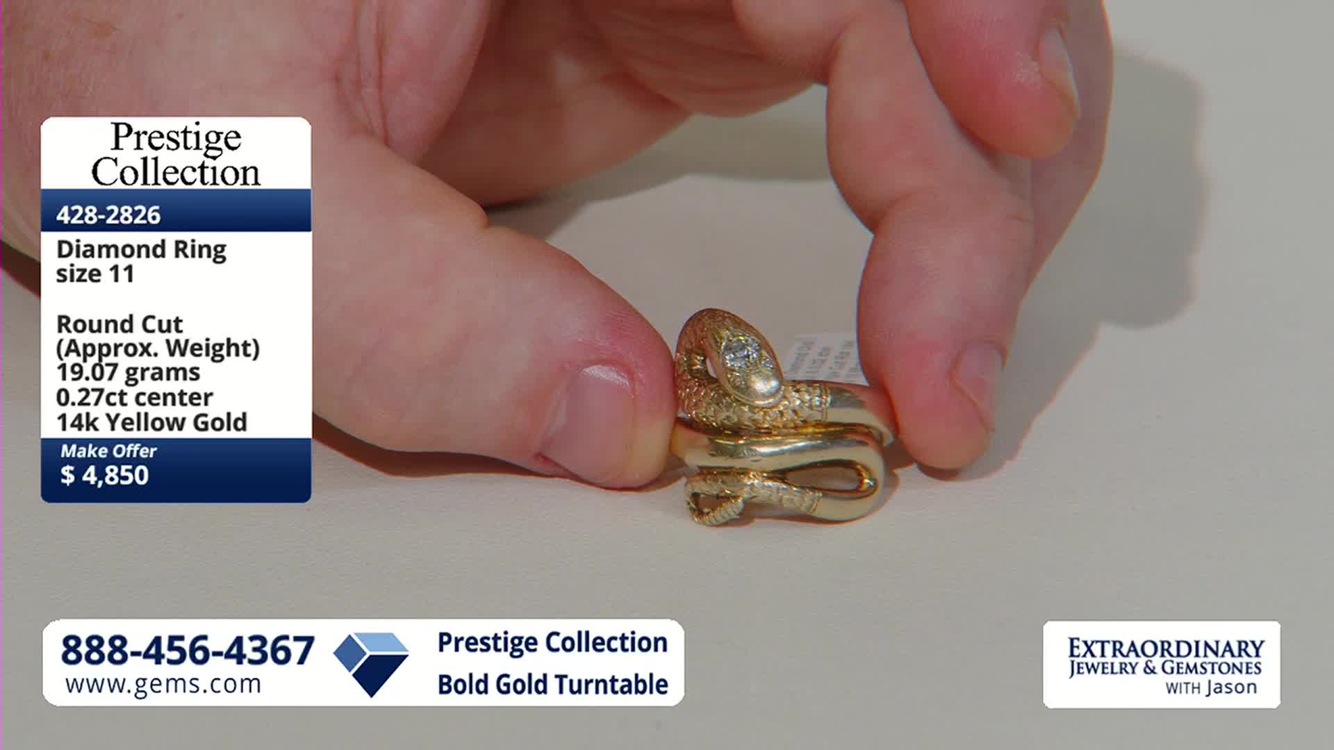 Fingers cradle a coiled gold snake ring, its diamond eyes glinting. The ring, a featured item from the Gem Shopping Network, rests on a pale surface.