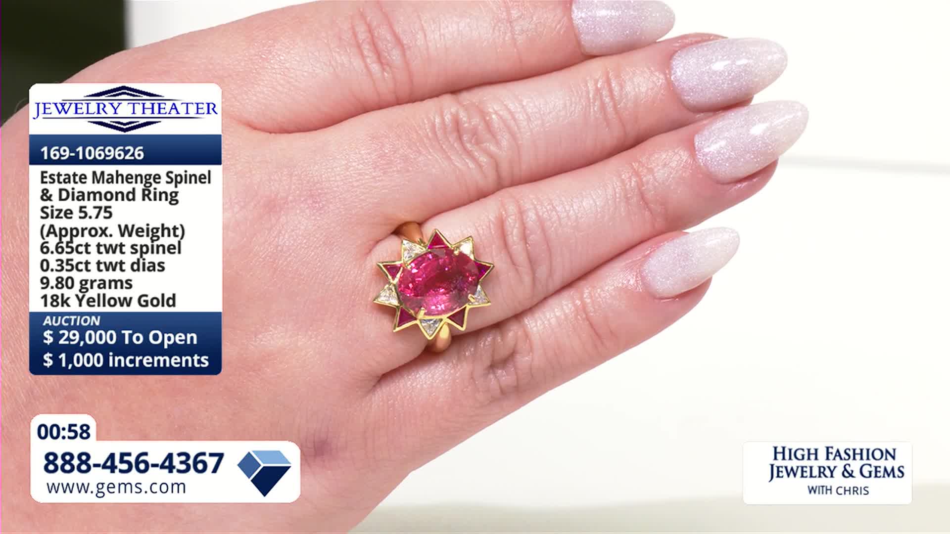A hand displays a large, oval pink spinel ring surrounded by diamonds and red stones. The ring is part of an auction on the Gem Shopping Network, with bidding starting at $29,000.
