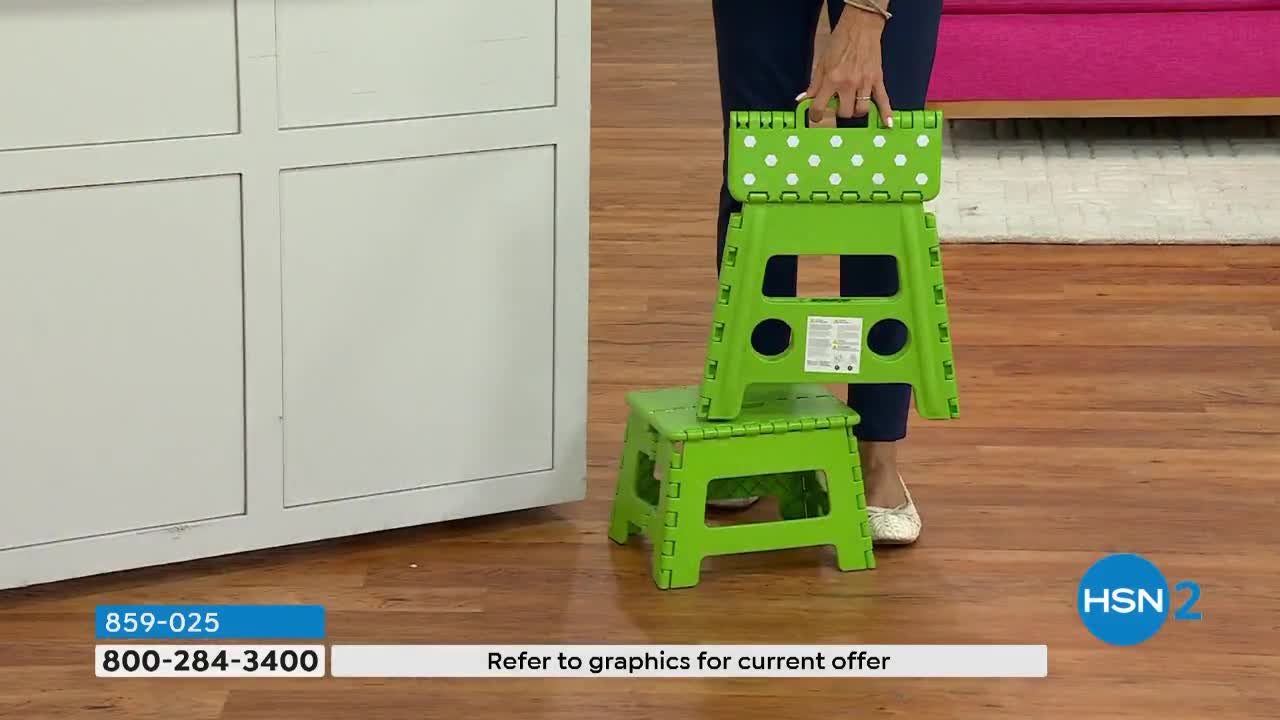A woman holds a folded green step stool with white polka dots, placing it on top of a smaller, unfolded one. The HSN2 logo is in the corner.

