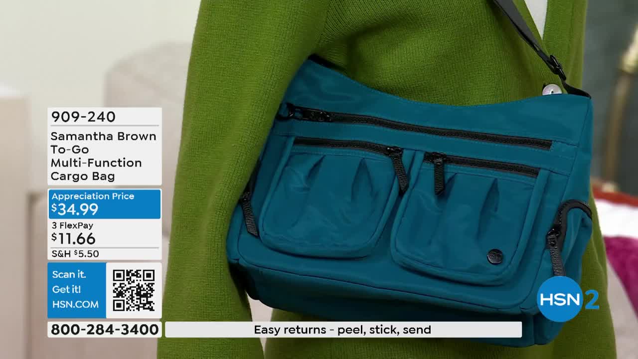 A teal bag with multiple pockets hangs from a shoulder strap. The HSN2 logo is visible, and the bag is shown against a green sweater.
