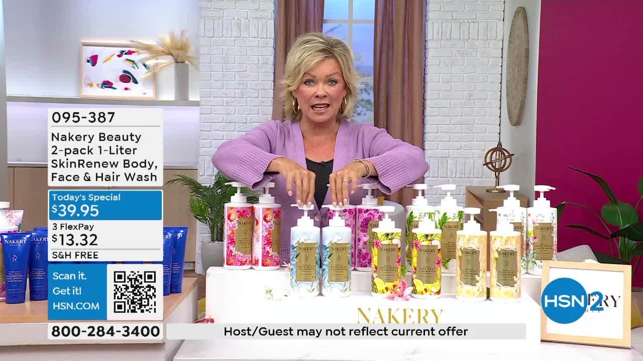 A woman in a lavender cardigan gestures toward an array of pump bottles, each adorned with floral designs. The bottles are arranged on a white platform, and the HSN2 logo is visible in the corner.
