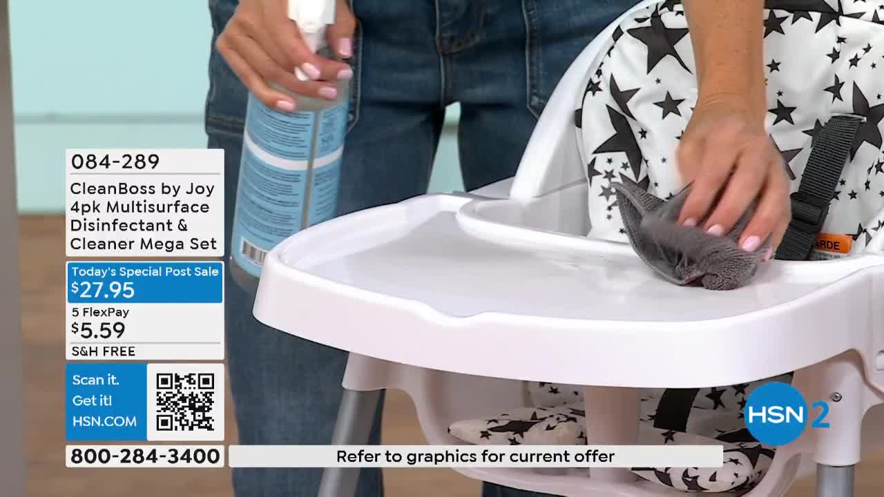 A woman is spraying a white high chair tray with cleaner from a bottle. She's wiping the tray with a gray cloth, likely demonstrating the product on HSN2.
