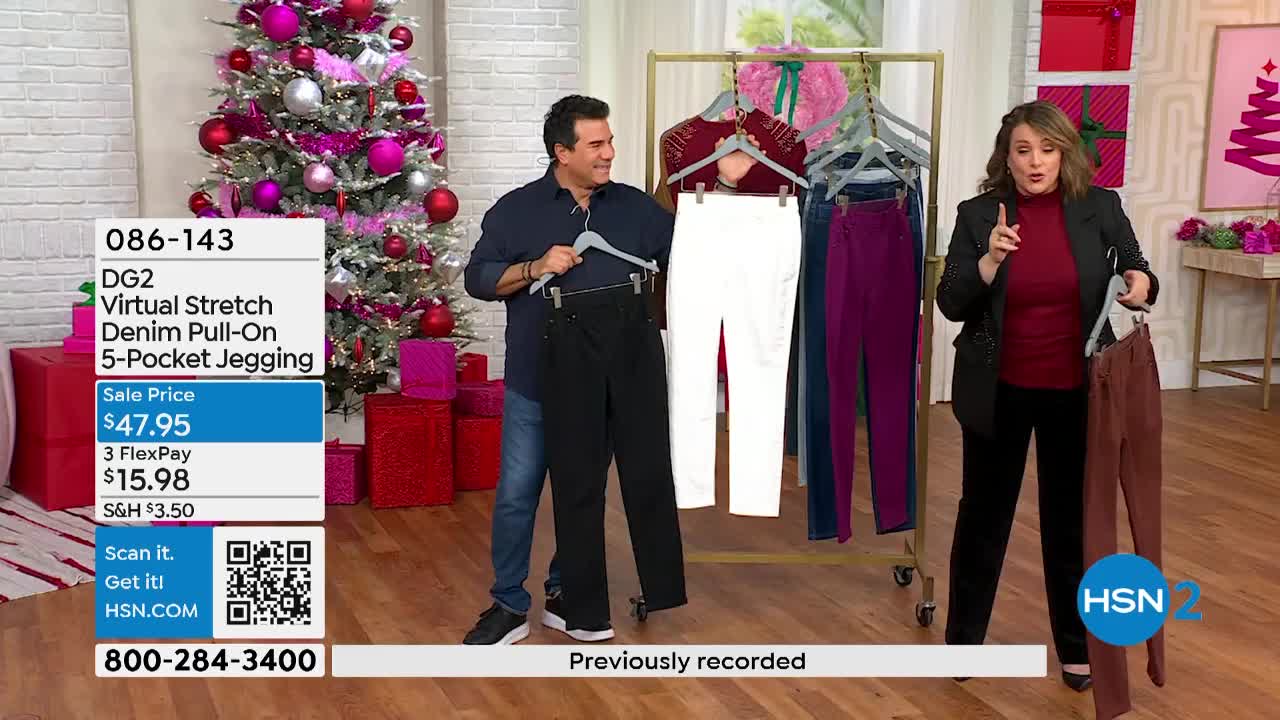 A man and woman stand in front of a rack of colorful pants, each holding a pair on a hanger. The man gestures towards the black pants in his hand, while the woman points to the brown pair she's holding.
