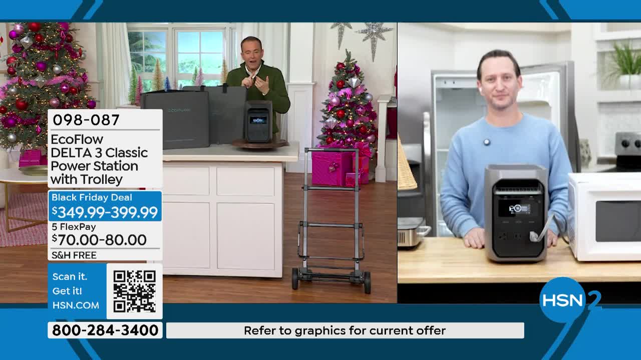 A presenter gestures toward a power station on a counter, while another man stands in front of a refrigerator, also with a power station. The HSN2 logo is visible in the lower right corner.
