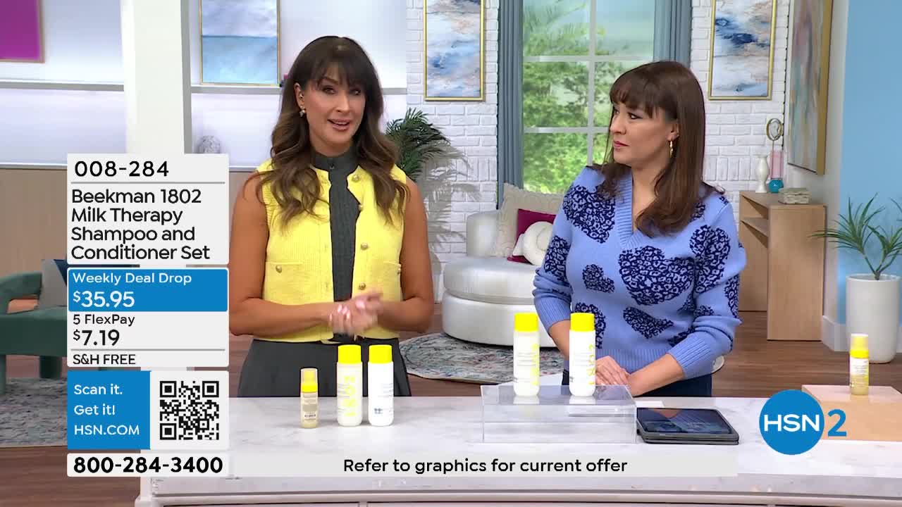 Two women stand on a set, presenting Beekman 1802 products. A graphic displays the item number, price, and ordering information for the Beekman 1802 Milk Therapy Shampoo and Conditioner Set.