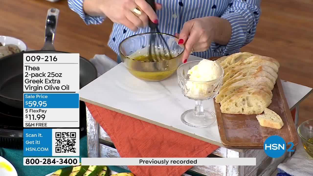 A woman whisks a golden liquid in a glass bowl, preparing a dressing. Sliced bread and a scoop of what looks like butter sit nearby, waiting to be served.
